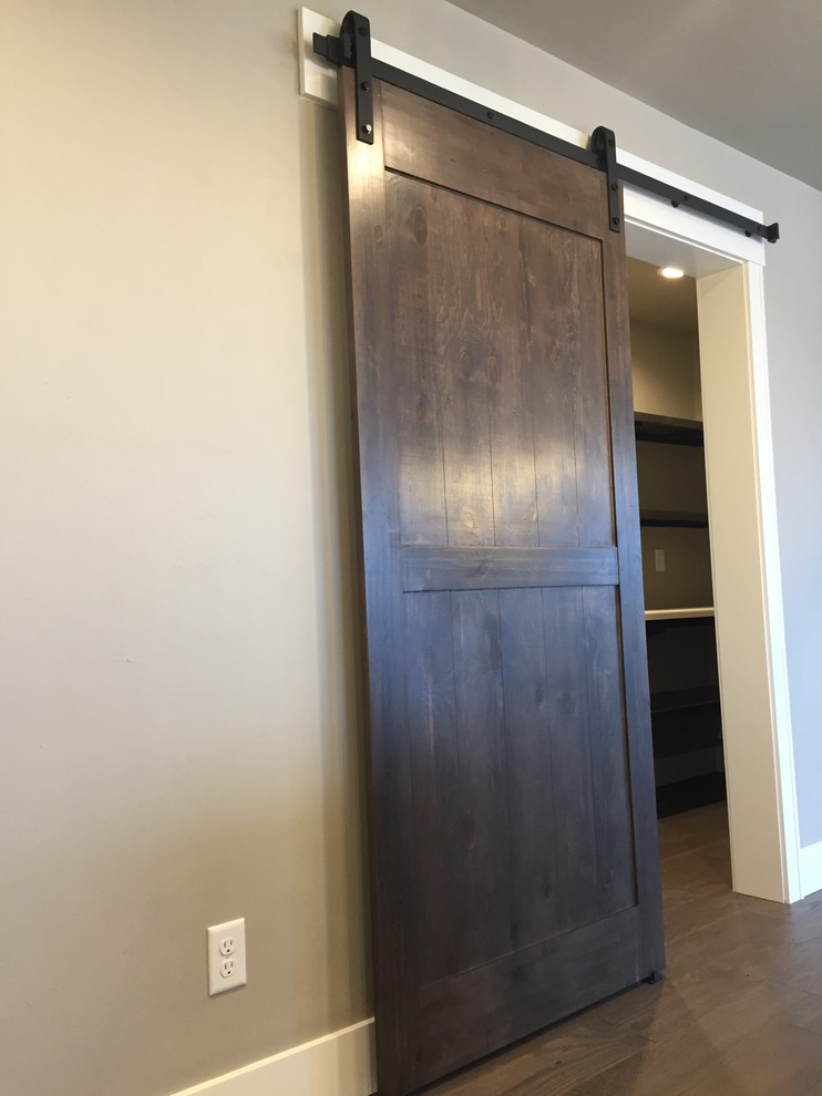 Example of a transitional dark wood floor and brown floor kitchen pantry design