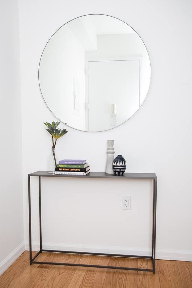 Inspiration for a small modern foyer in New York with white walls and light hardwood floors.