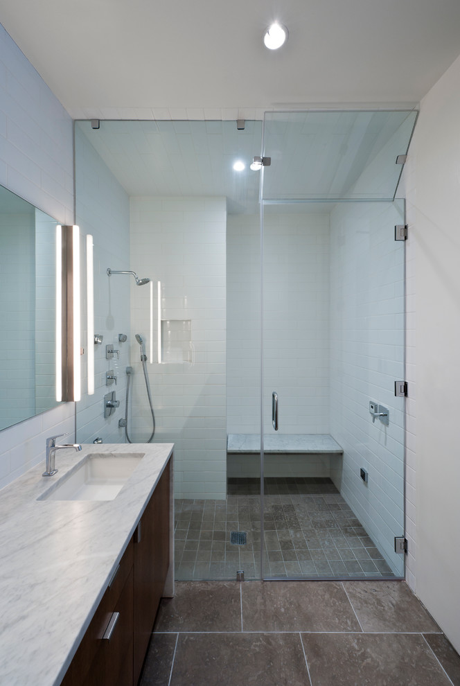 Modern bathroom in San Francisco with marble benchtops and subway tile.