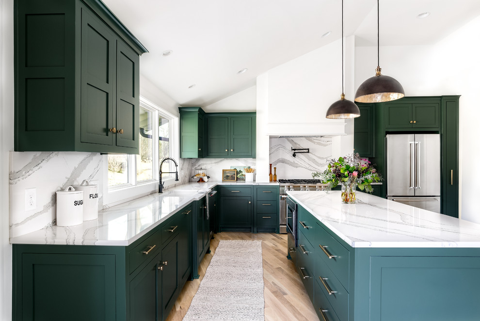 Inspiration for a transitional l-shaped kitchen in Kansas City with green cabinets, stainless steel appliances, light hardwood floors, with island, an undermount sink, shaker cabinets, white splashback, beige floor and white benchtop.