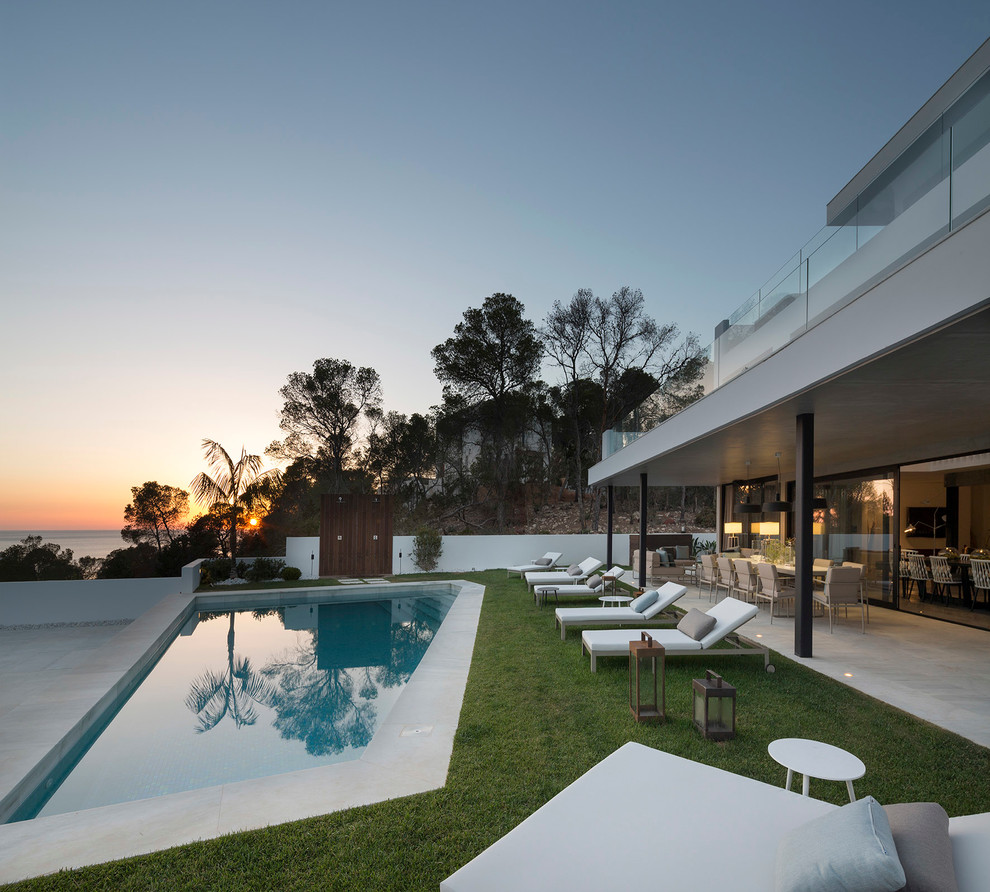 Mid-sized contemporary front yard custom-shaped lap pool in Bilbao with a pool house.