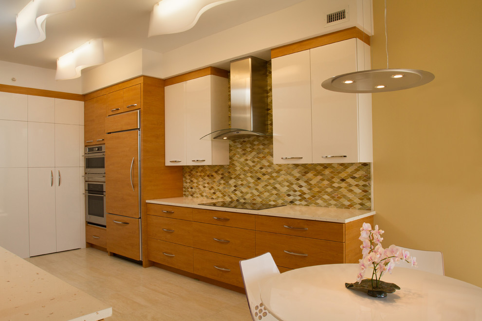 Photo of a contemporary galley eat-in kitchen in Tampa with an undermount sink, flat-panel cabinets, white cabinets, quartz benchtops, multi-coloured splashback, mosaic tile splashback, panelled appliances and porcelain floors.