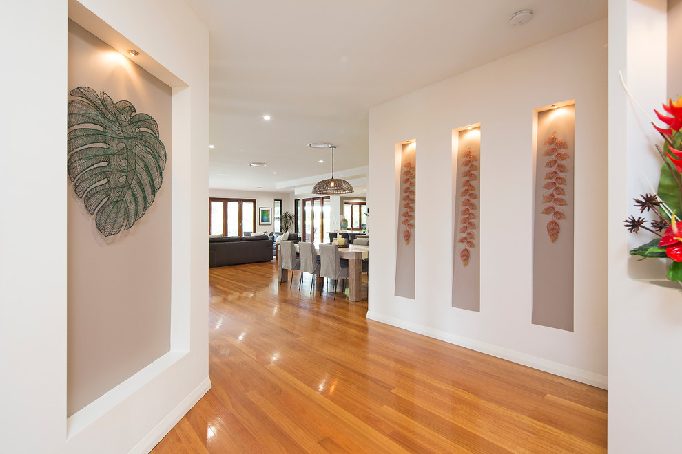 Mid-sized tropical hallway in Gold Coast - Tweed with multi-coloured walls and medium hardwood floors.