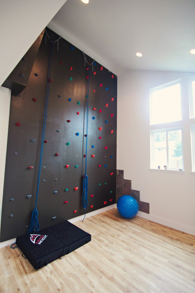 Photo of a large traditional home climbing wall in Seattle with white walls and light hardwood floors.