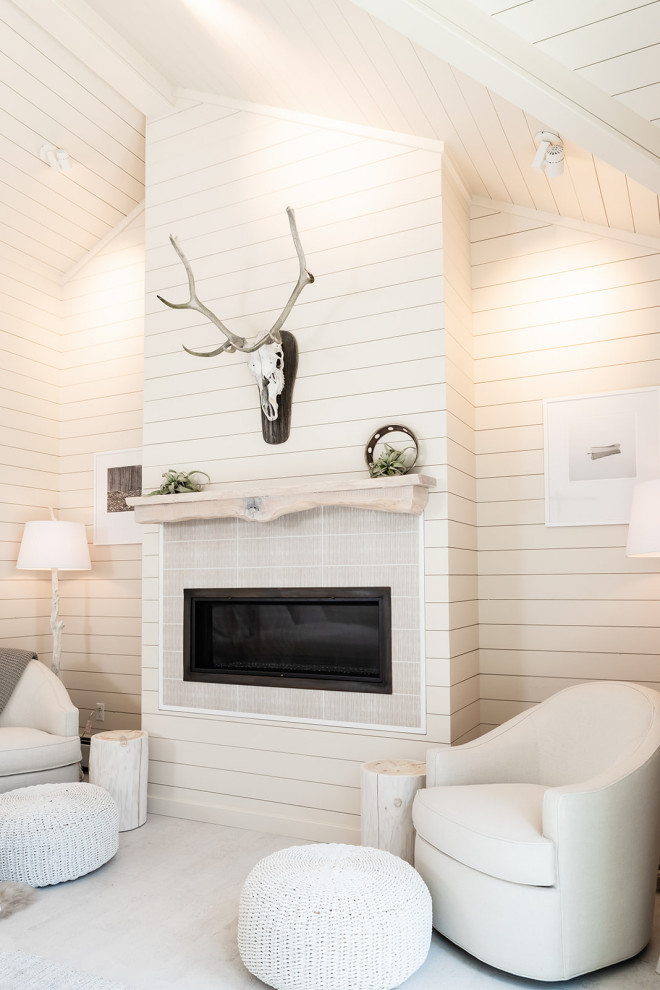 Inspiration for a large beach style master bedroom in Burlington with beige walls, light hardwood floors, a standard fireplace, white floor, timber and planked wall panelling.