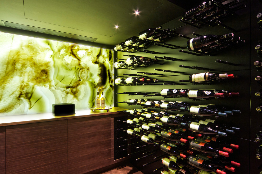 This is an example of a mid-sized modern wine cellar in New York with storage racks.