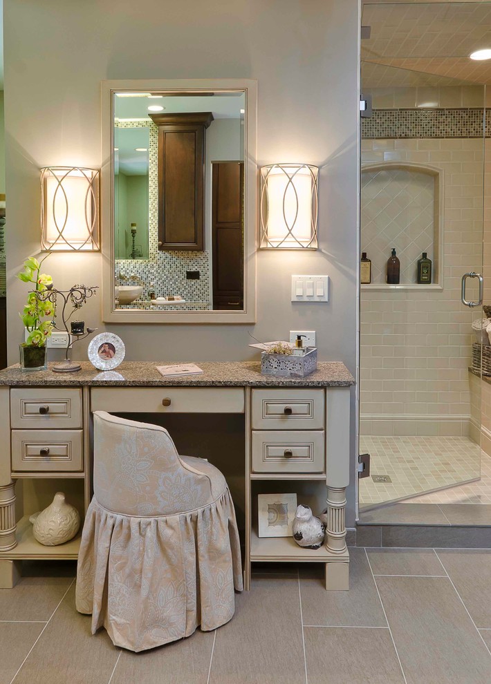 Photo of a traditional bathroom in Chicago with raised-panel cabinets, beige cabinets and beige tile.