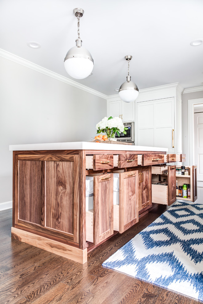 Inspiration for a transitional dark wood floor kitchen remodel in New York with an undermount sink, shaker cabinets, white cabinets, white backsplash, subway tile backsplash, paneled appliances and an island