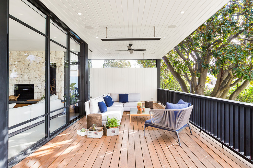Photo of a contemporary deck in Melbourne with a roof extension.