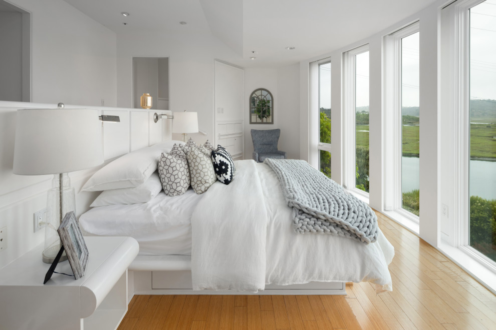На фото: огромная хозяйская спальня в морском стиле с белыми стенами с