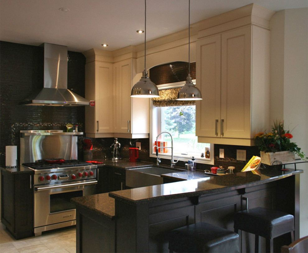 Example of a mid-sized transitional u-shaped porcelain tile eat-in kitchen design in Toronto with a farmhouse sink, shaker cabinets, dark wood cabinets, quartz countertops, brown backsplash, ceramic backsplash, stainless steel appliances and a peninsula
