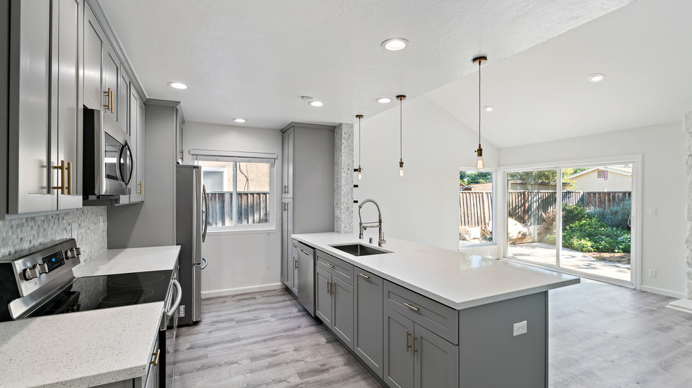 Design ideas for a small transitional galley open plan kitchen in San Francisco with an undermount sink, shaker cabinets, grey cabinets, quartz benchtops, grey splashback, a peninsula and white benchtop.
