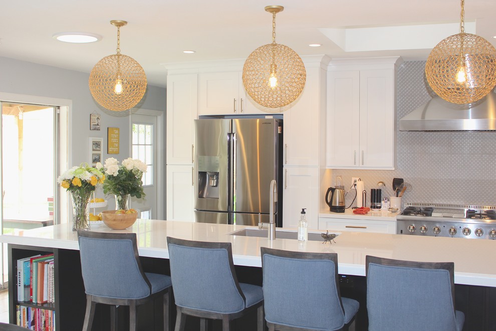 Open concept kitchen - large transitional l-shaped ceramic tile and beige floor open concept kitchen idea in Phoenix with an undermount sink, shaker cabinets, white cabinets, quartzite countertops, gray backsplash, stainless steel appliances and an island