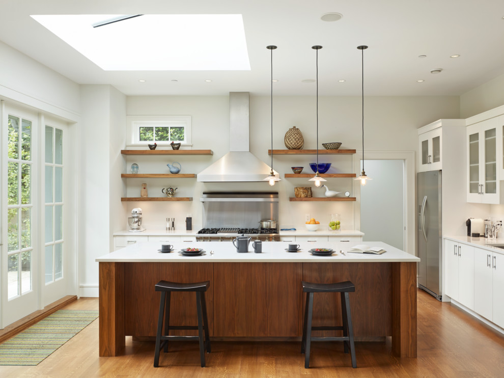 Inspiration for a mid-sized contemporary l-shaped kitchen in Vancouver with open cabinets, with island, an undermount sink, metallic splashback, stainless steel appliances and medium hardwood floors.