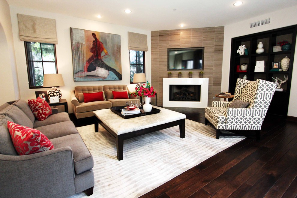 This is an example of a contemporary enclosed living room in Orange County with beige walls and a corner fireplace.