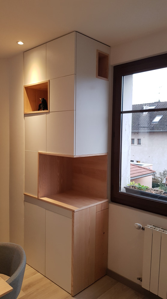 Idee per un piccolo ufficio moderno con pareti bianche, pavimento in laminato e scrivania incassata