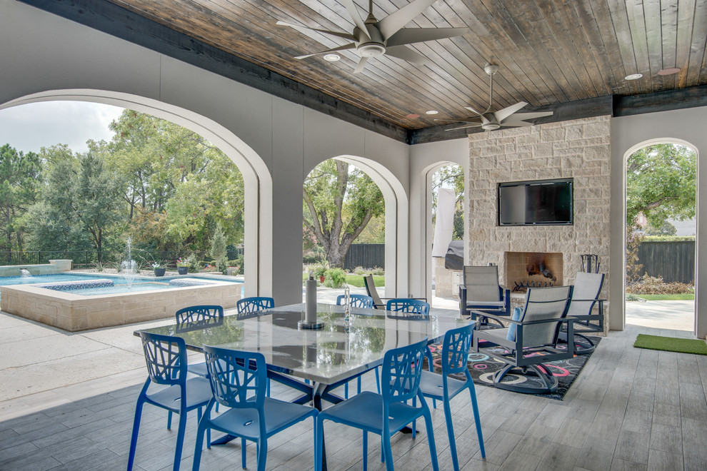 Transitional backyard patio in Dallas with a roof extension and with fireplace.