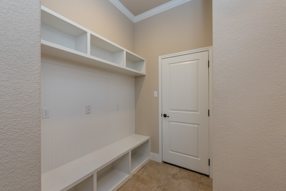 Design ideas for a large traditional mudroom in Austin with beige walls, ceramic floors, a pivot front door, a white front door and beige floor.