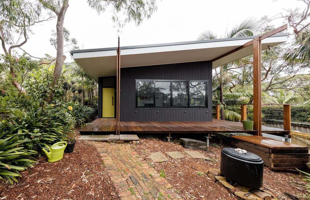 Inspiration for a small contemporary one-storey black exterior in Sydney with wood siding and a shed roof.