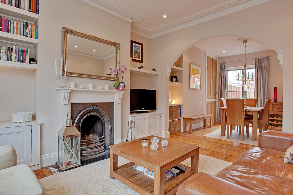 Traditional enclosed living room in Other with a standard fireplace and a freestanding tv.