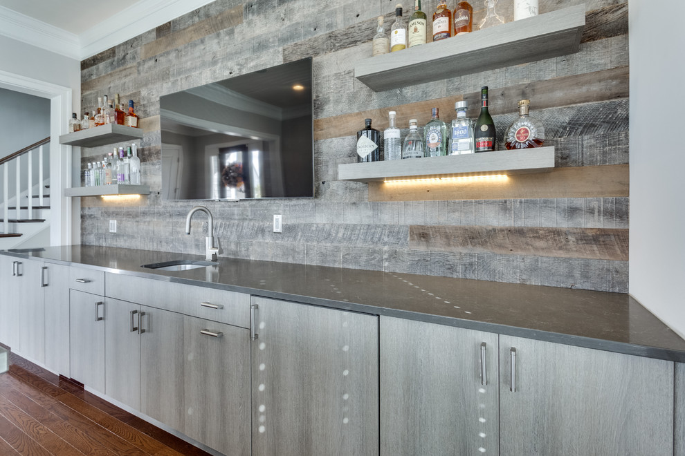 Inspiration for a large contemporary single-wall wet bar in DC Metro with an undermount sink, flat-panel cabinets, grey cabinets, grey splashback, timber splashback, medium hardwood floors and brown floor.