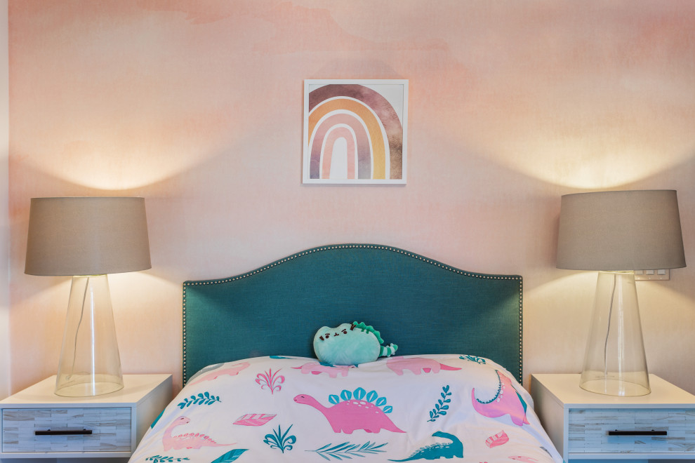 This is an example of a mid-sized contemporary kids' bedroom for kids 4-10 years old and girls in Los Angeles with pink walls and wallpaper.