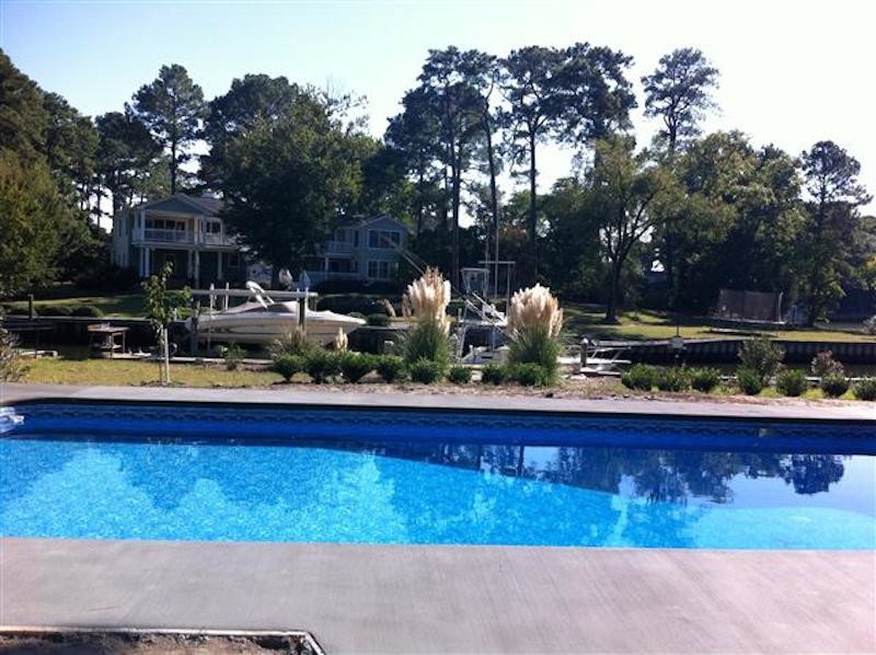 Pool - backyard custom-shaped pool idea