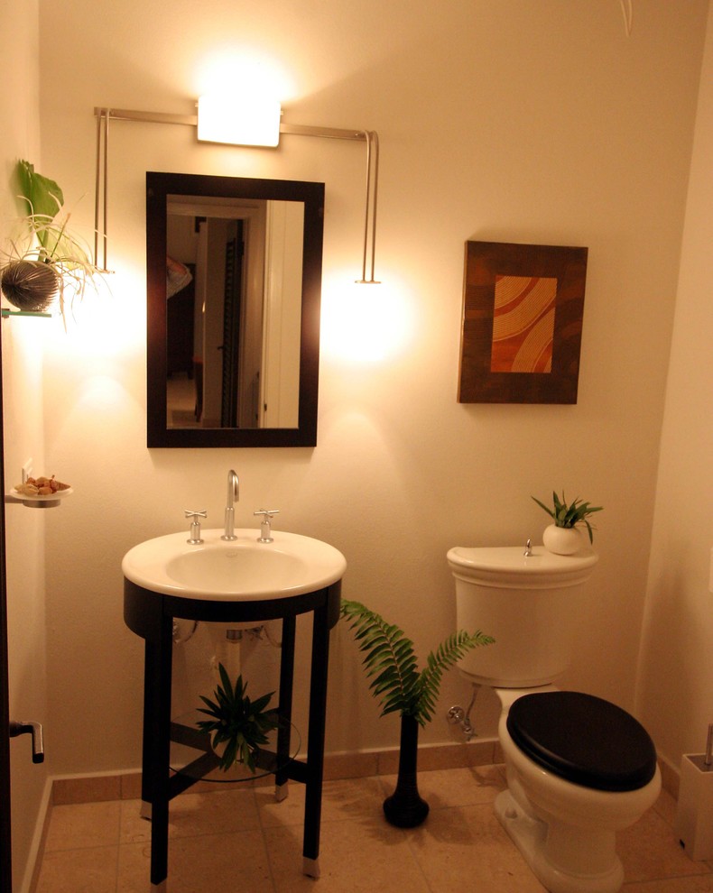 This is an example of a tropical powder room in Other.