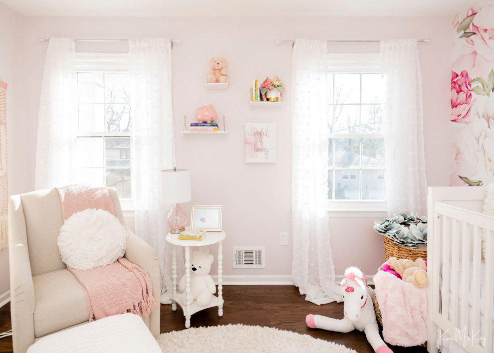 Inspiration for a medium sized classic nursery for girls in New York with pink walls, dark hardwood flooring, brown floors and wallpapered walls.