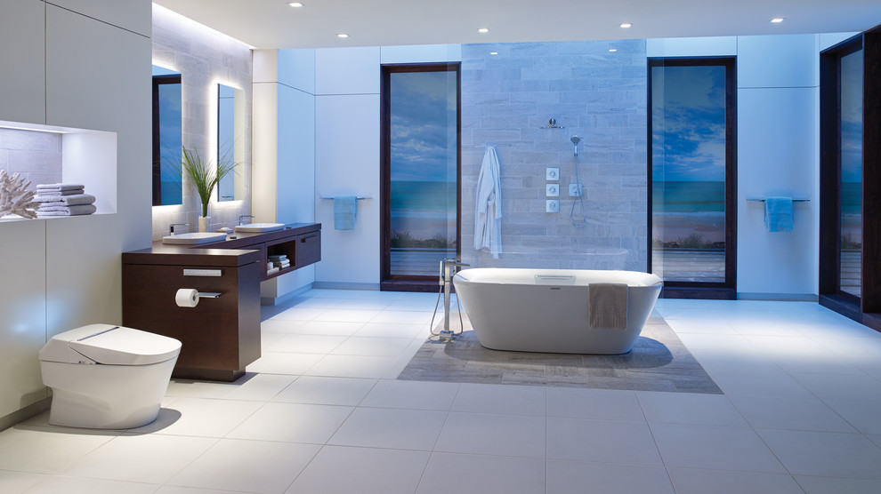 Inspiration for an expansive modern master bathroom in DC Metro with flat-panel cabinets, brown cabinets, a freestanding tub, an open shower, a one-piece toilet, beige tile, marble, white walls, ceramic floors, a drop-in sink, wood benchtops, beige floor and an open shower.