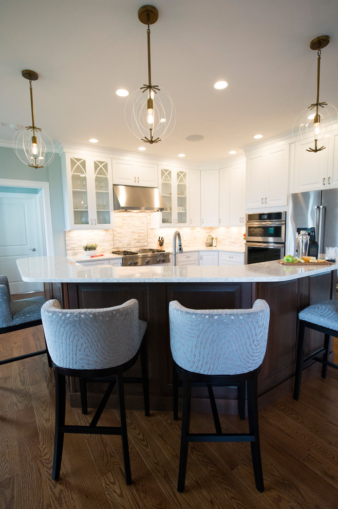 Transitional l-shaped medium tone wood floor eat-in kitchen photo in Boston with white cabinets, granite countertops, gray backsplash, stainless steel appliances and an island