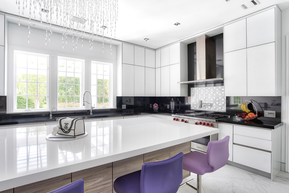 Inspiration for an expansive contemporary u-shaped open plan kitchen in New York with flat-panel cabinets, a drop-in sink, white cabinets, quartz benchtops, black splashback, stone slab splashback, panelled appliances, porcelain floors, with island, white floor and white benchtop.