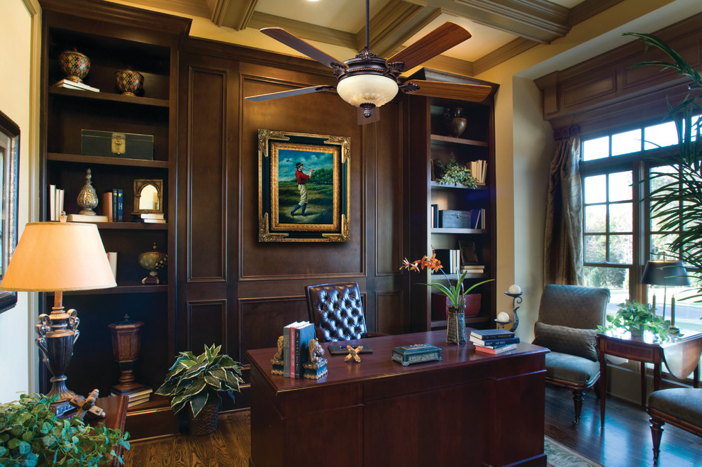 This is an example of a large traditional home office in Chicago with dark hardwood floors and a freestanding desk.