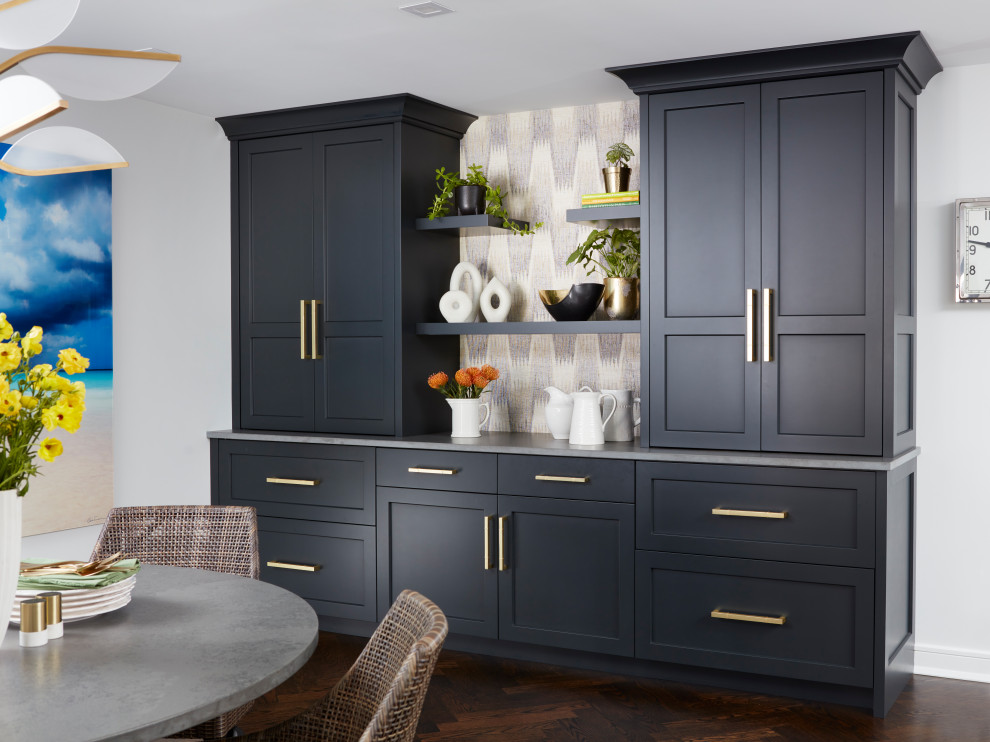 Photo of a large transitional single-wall home bar in New York with shaker cabinets, black cabinets, quartz benchtops, white splashback, engineered quartz splashback, painted wood floors, brown floor and grey benchtop.