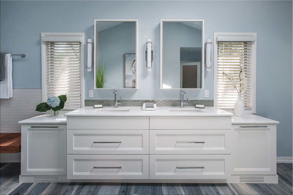 Design ideas for a large modern master bathroom in Chicago with shaker cabinets, white cabinets, a freestanding tub, a curbless shower, a two-piece toilet, beige tile, porcelain tile, blue walls, porcelain floors, an undermount sink, engineered quartz benchtops, blue floor, an open shower and white benchtops.
