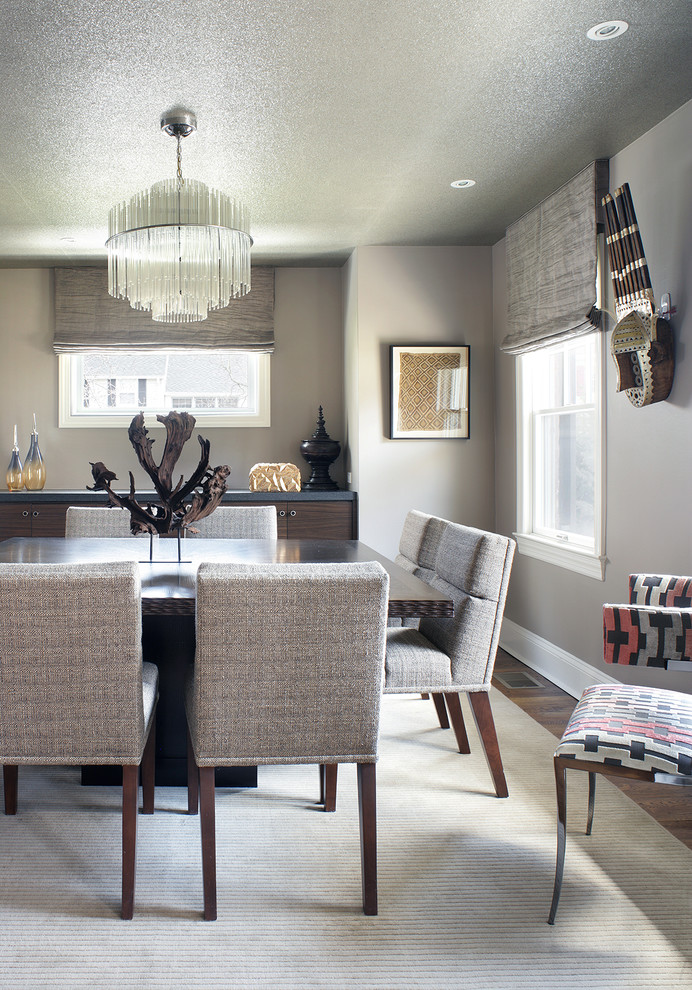 Contemporary dining room in New York with grey walls, medium hardwood floors and no fireplace.