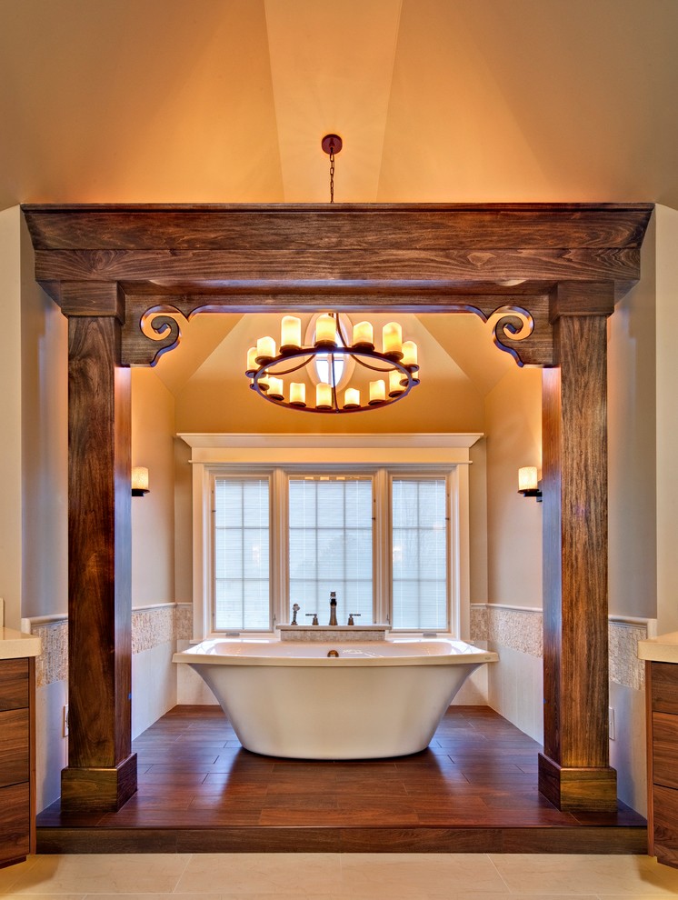 Inspiration for a large transitional master bathroom in Chicago with a freestanding tub, beige tile, flat-panel cabinets, medium wood cabinets, porcelain tile, beige walls, porcelain floors, an undermount sink, engineered quartz benchtops and beige floor.