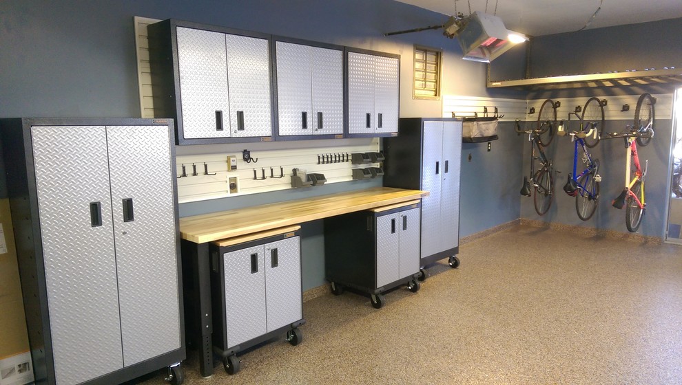 Mid-sized transitional attached two-car garage workshop photo in Denver