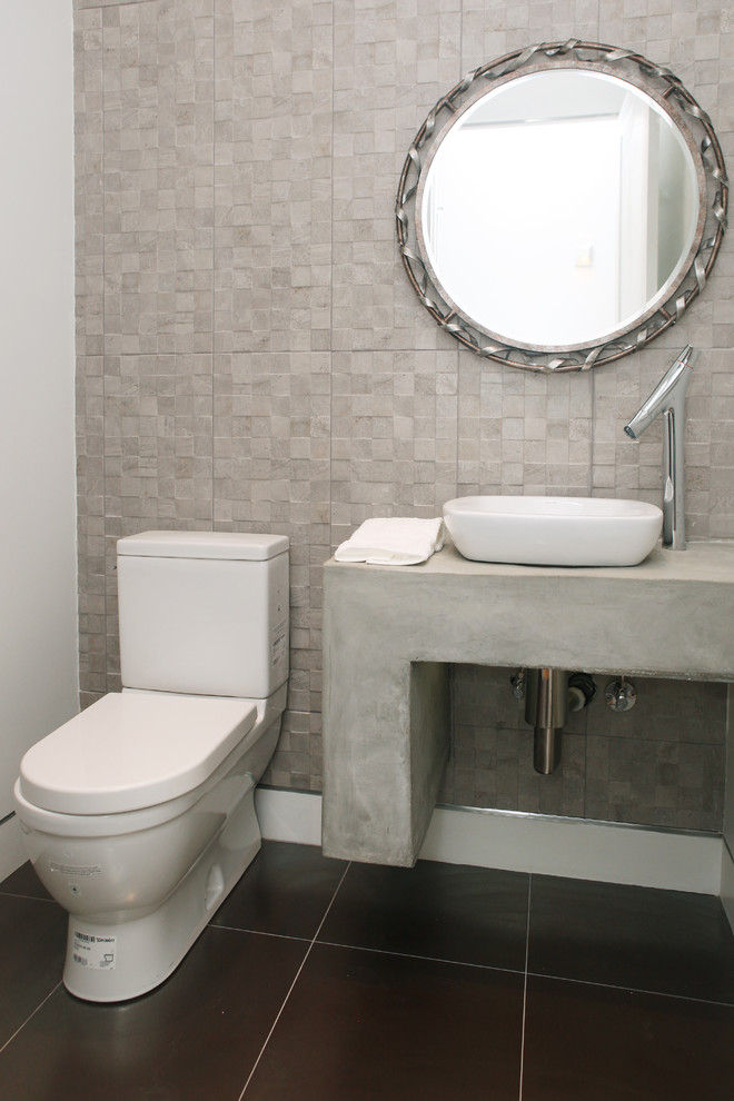 Inspiration for a small contemporary powder room in Los Angeles with concrete benchtops.