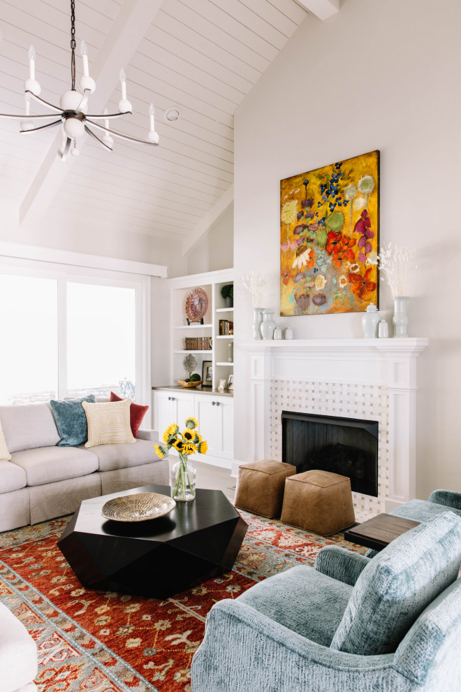 This is an example of a transitional living room in Other with grey walls, a standard fireplace, a tile fireplace surround, exposed beam, timber and vaulted.