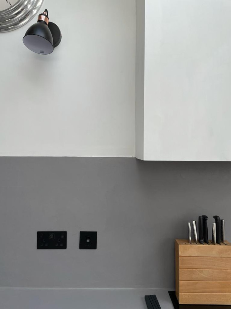 Inspiration for a small eclectic galley open plan kitchen with concrete flooring, no island, grey floors, grey worktops, exposed beams and feature lighting.