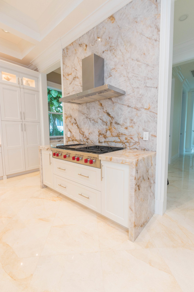 Huge transitional u-shaped marble floor and white floor open concept kitchen photo with an undermount sink, flat-panel cabinets, white cabinets, quartzite countertops, white backsplash, stone slab backsplash and two islands