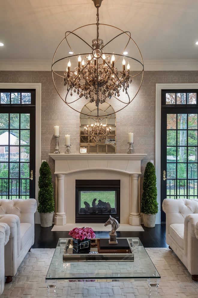 Photo of a transitional formal enclosed living room in DC Metro with grey walls, a two-sided fireplace, a plaster fireplace surround and black floor.