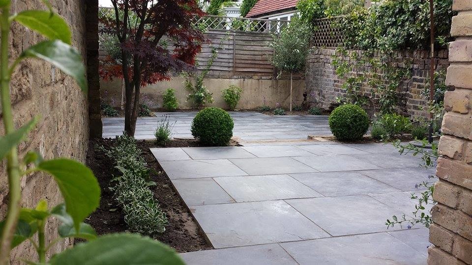 Example of a small trendy backyard stone patio design in London