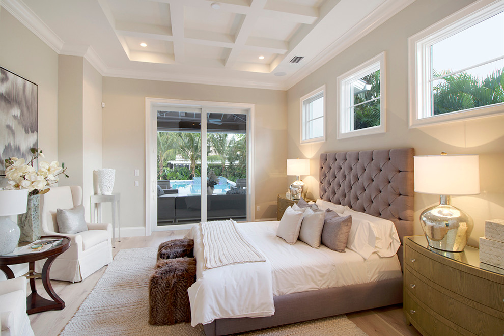 Transitional master bedroom in Miami with grey walls and light hardwood floors.