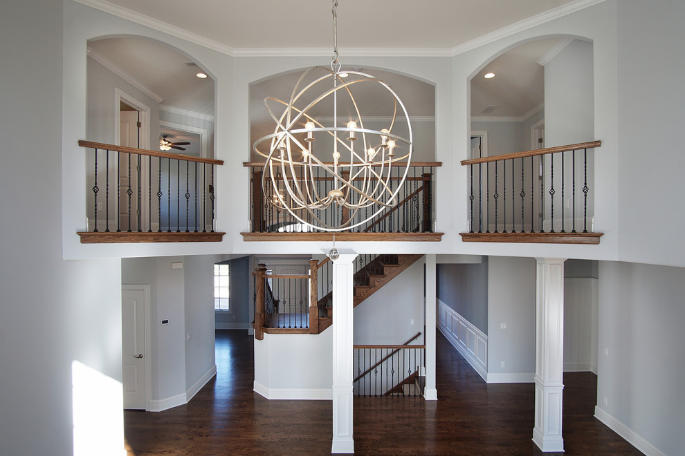 Large transitional open concept medium tone wood floor home design photo in Chicago with gray walls, a standard fireplace and a wood fireplace surround