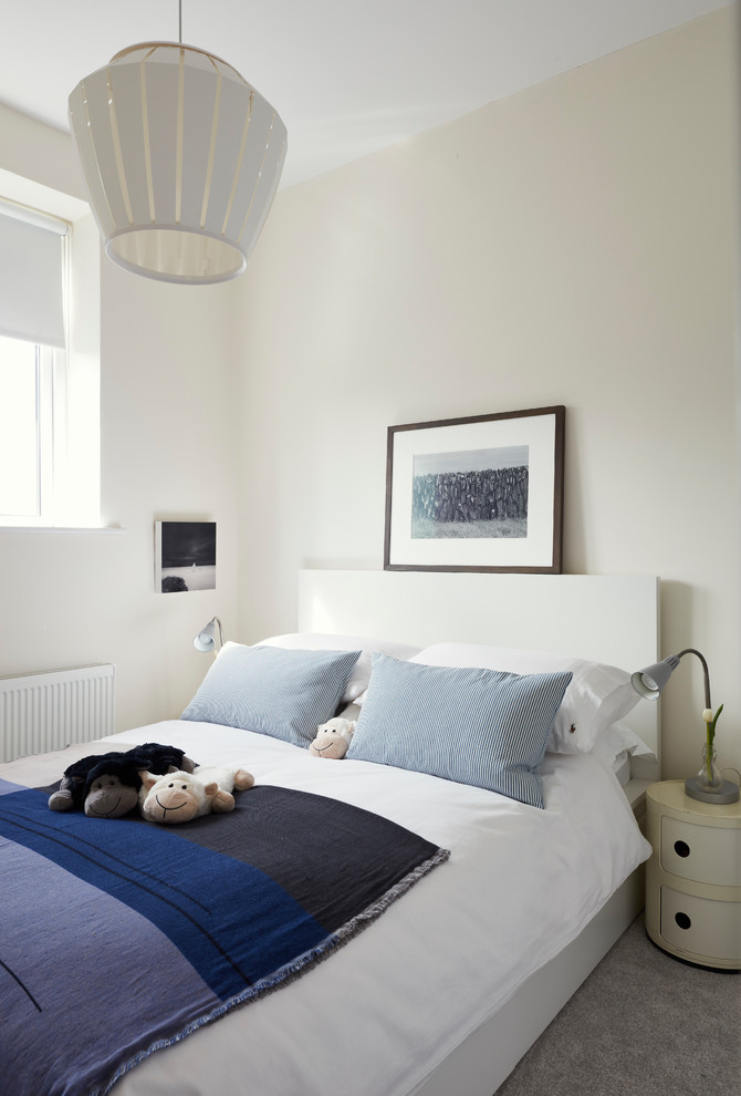 This is an example of a small scandinavian master bedroom in Dublin with white walls, vinyl floors and white floor.