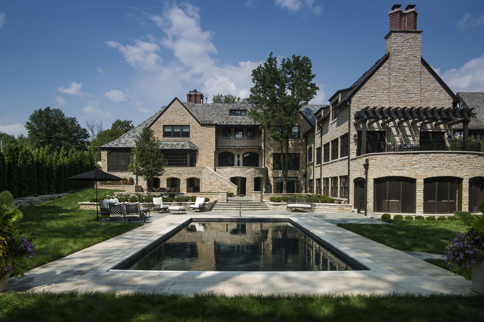 Mid-sized elegant backyard stone and rectangular pool photo in Chicago