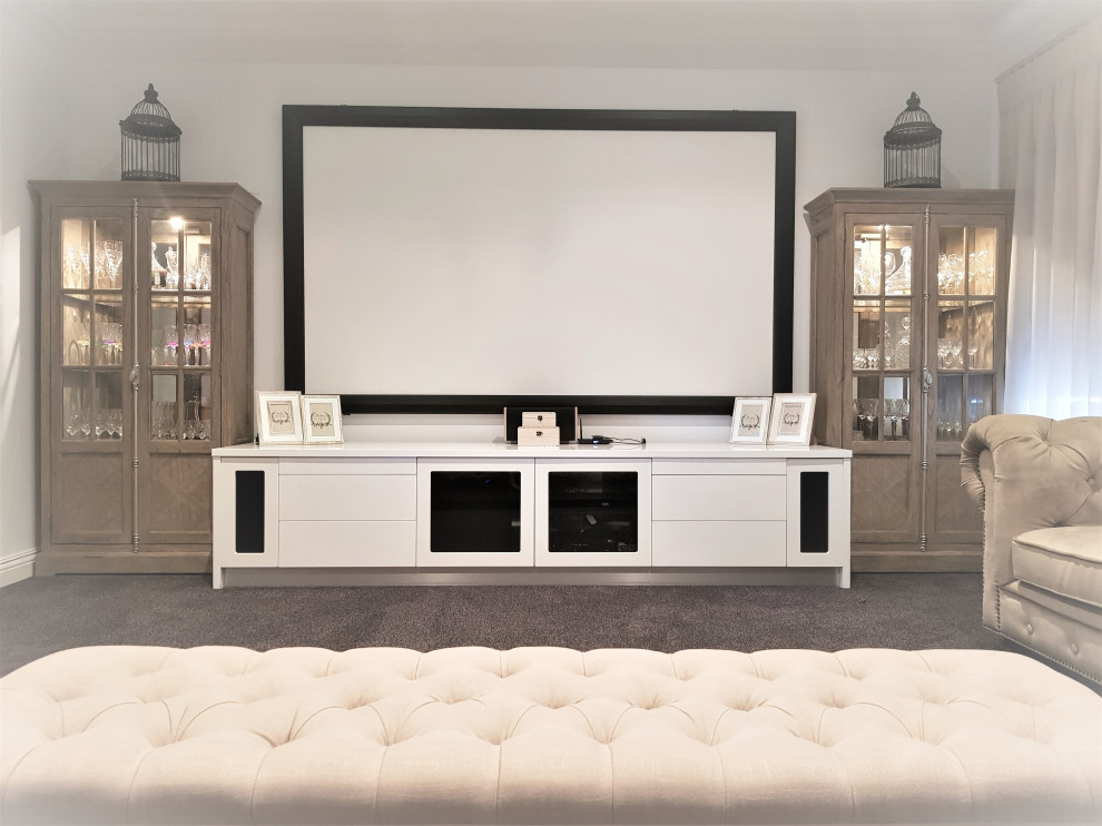 Mid-sized transitional home theatre in Perth with carpet, a projector screen and grey floor.