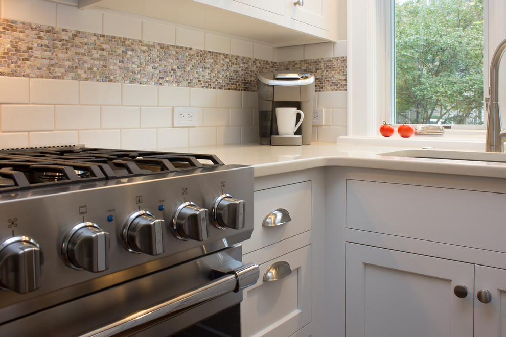 Small transitional u-shaped dark wood floor and brown floor eat-in kitchen photo in Raleigh with an undermount sink, recessed-panel cabinets, white cabinets, quartz countertops, white backsplash, subway tile backsplash, stainless steel appliances, no island and beige countertops
